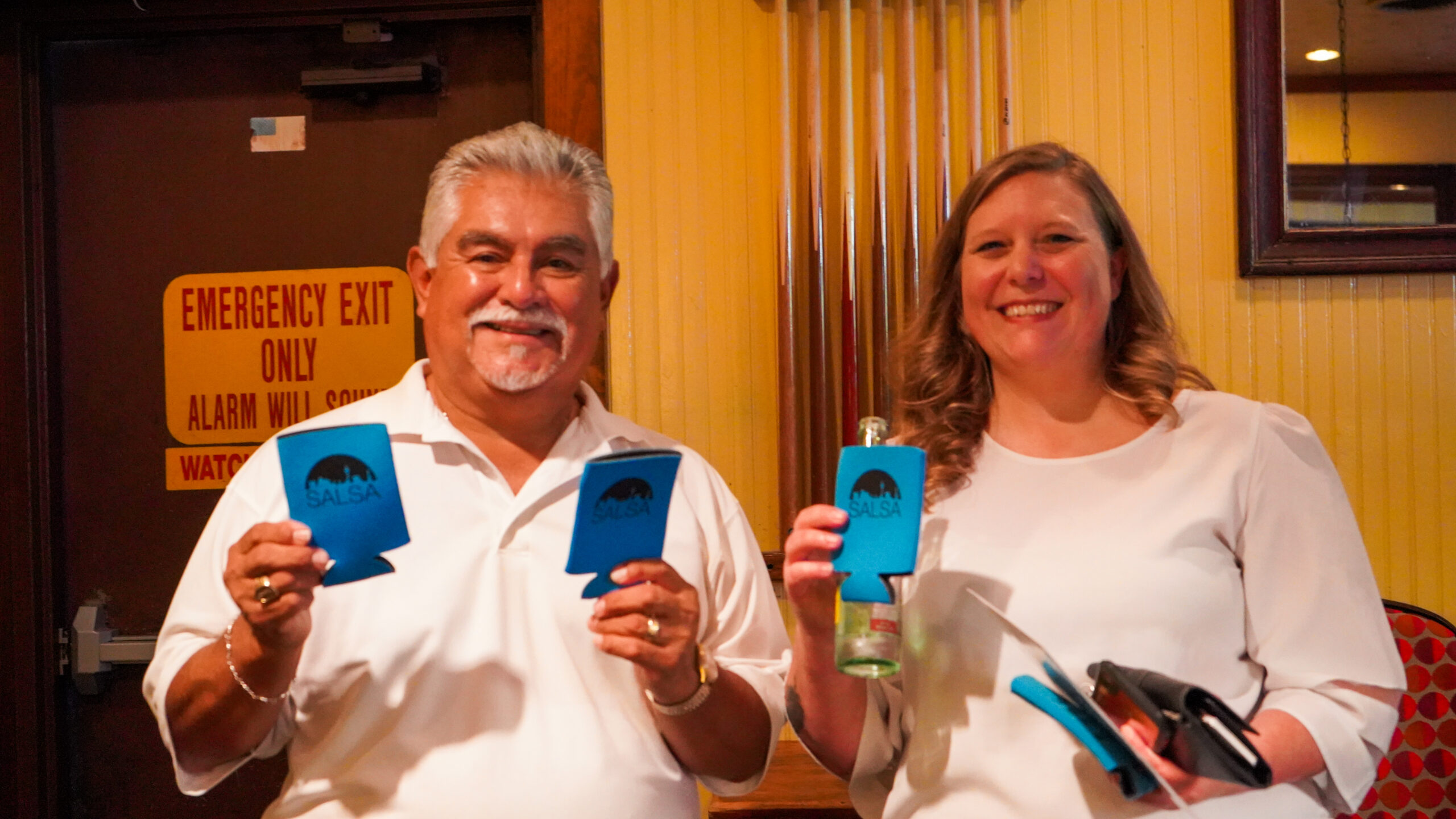 Joe Piña and Mandy Taylor hold SALSA koozies